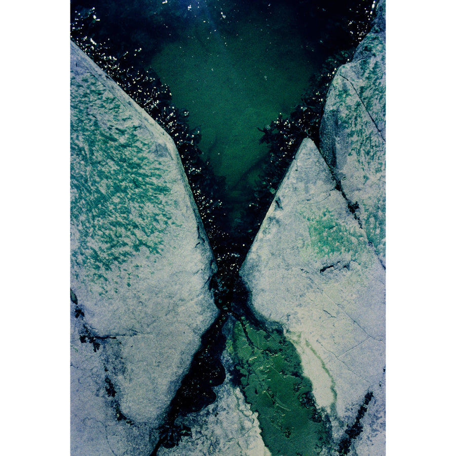 Les amoureux, par Éva-Maude TC. Photographie sur pellicule 35 mm, 18” x 36”, 2024. Rocher, eau et algues, tous vert émeraude.