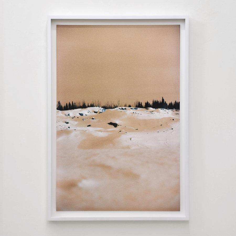 Snow White Meringue d’Éva-Maude TC. Grand tirage photographique d’une composition hivernale, couleur caramel. Horizon noir d’épinettes.